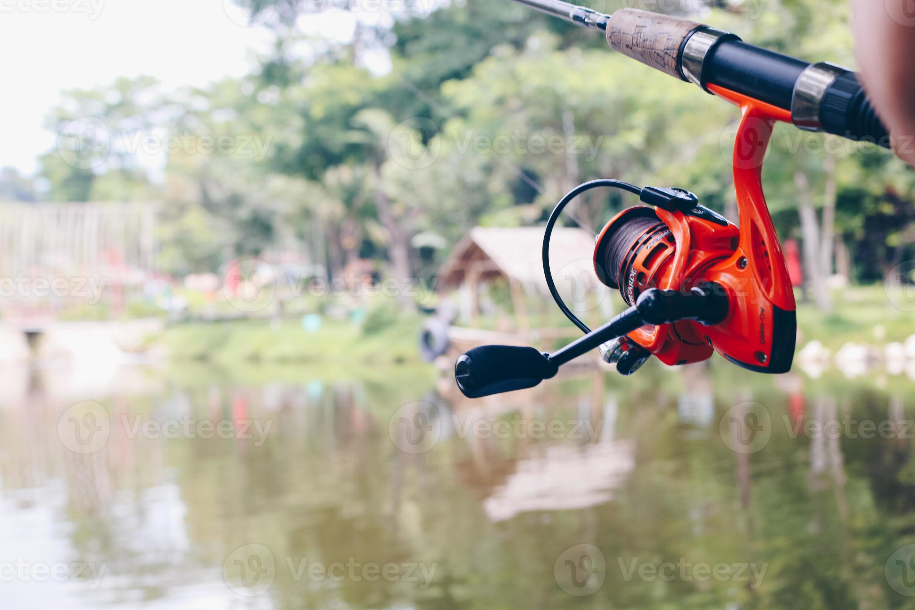 Close up of spinning with the fishing reel in the hand, fishing