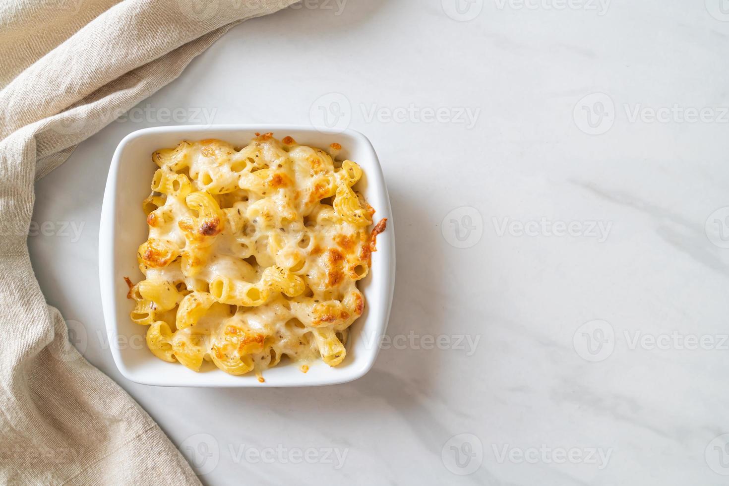 American mac and cheese, macaroni pasta in cheesy sauce photo