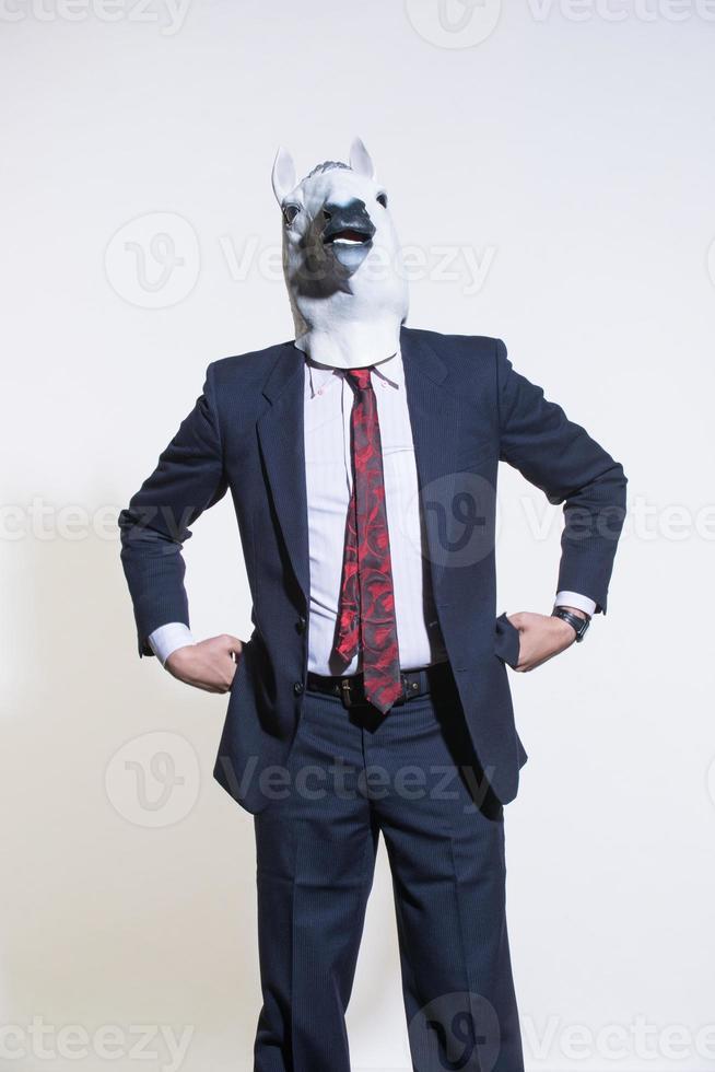 man with a horse mask on a light background photo