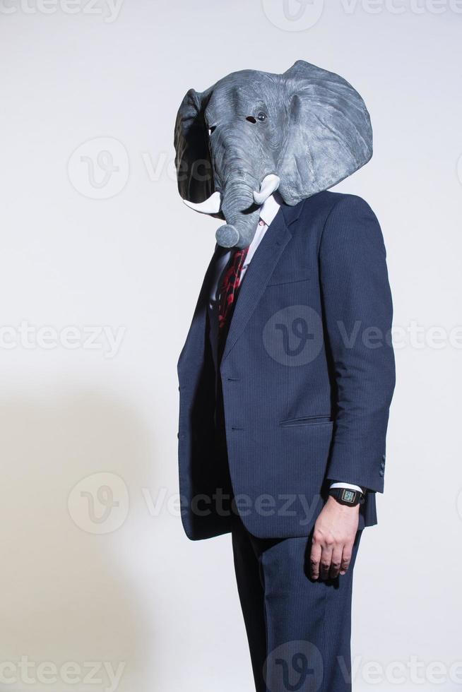 man with an elephant mask on a light background photo