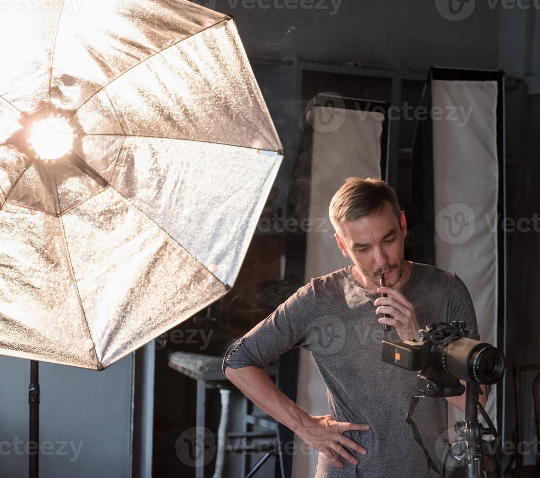 photographer in the process of shooting in the Studio photo