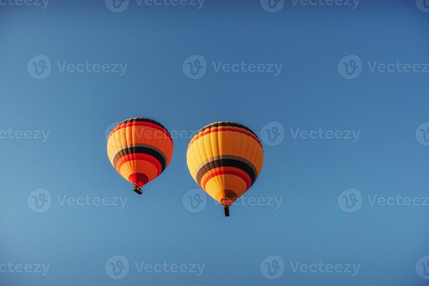 group of colorful hot air balloons against a blue sky photo