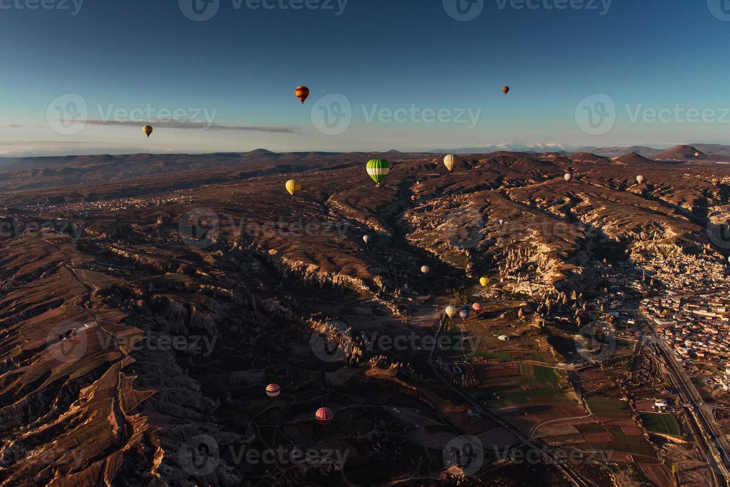 Hot air balloon flying over rock landscape at Cappadocia Turkey. photo