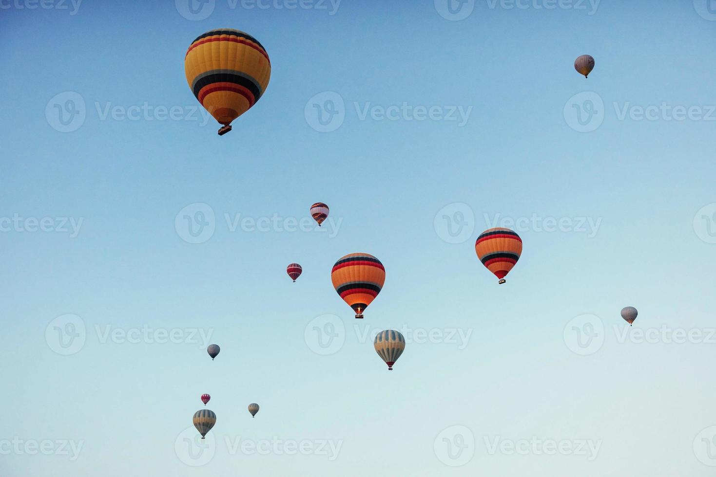 group of colorful hot air balloons against a blue sky photo