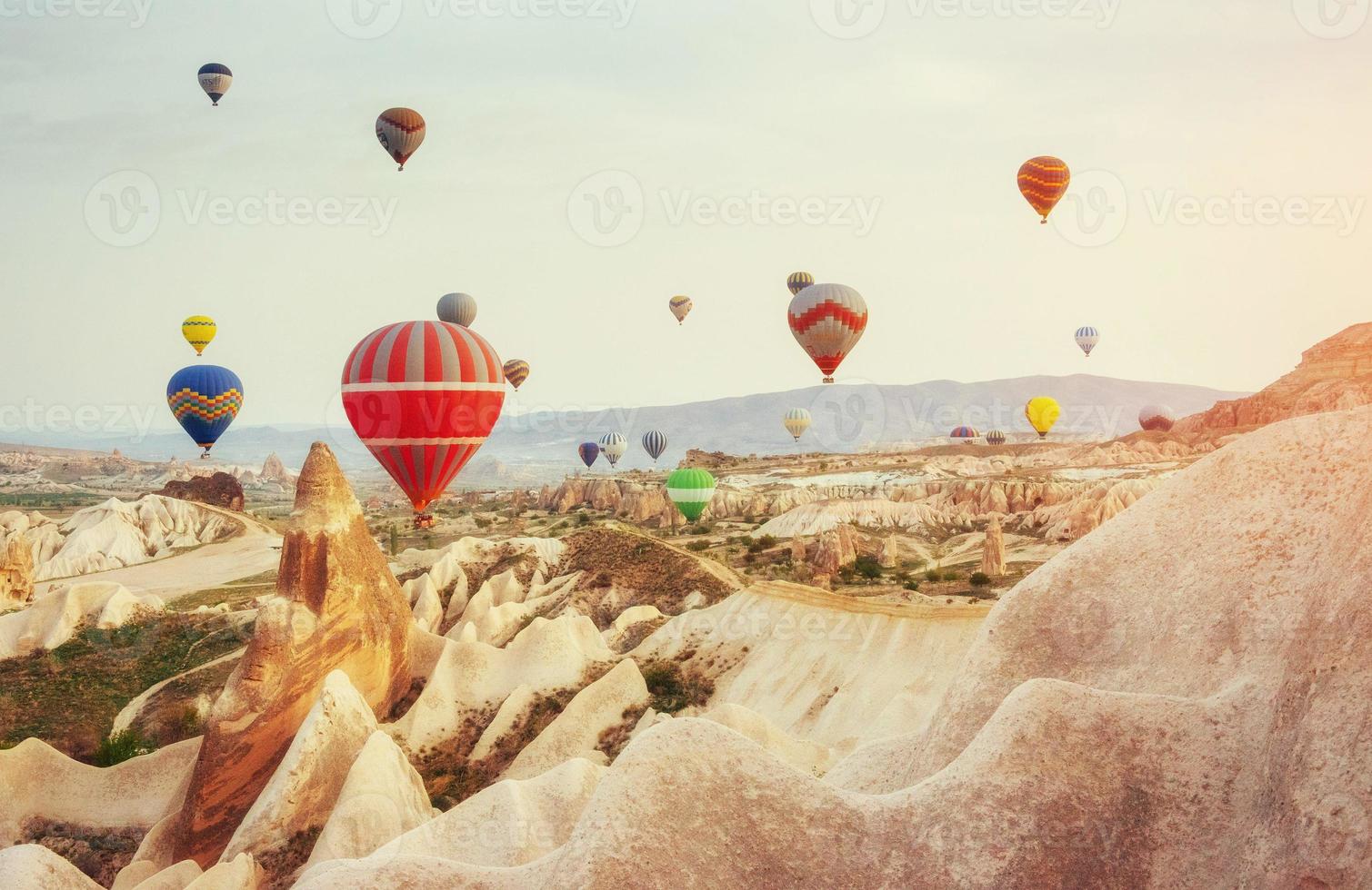 Colorful hot air balloons flying over Red valley at Cappadocia, photo