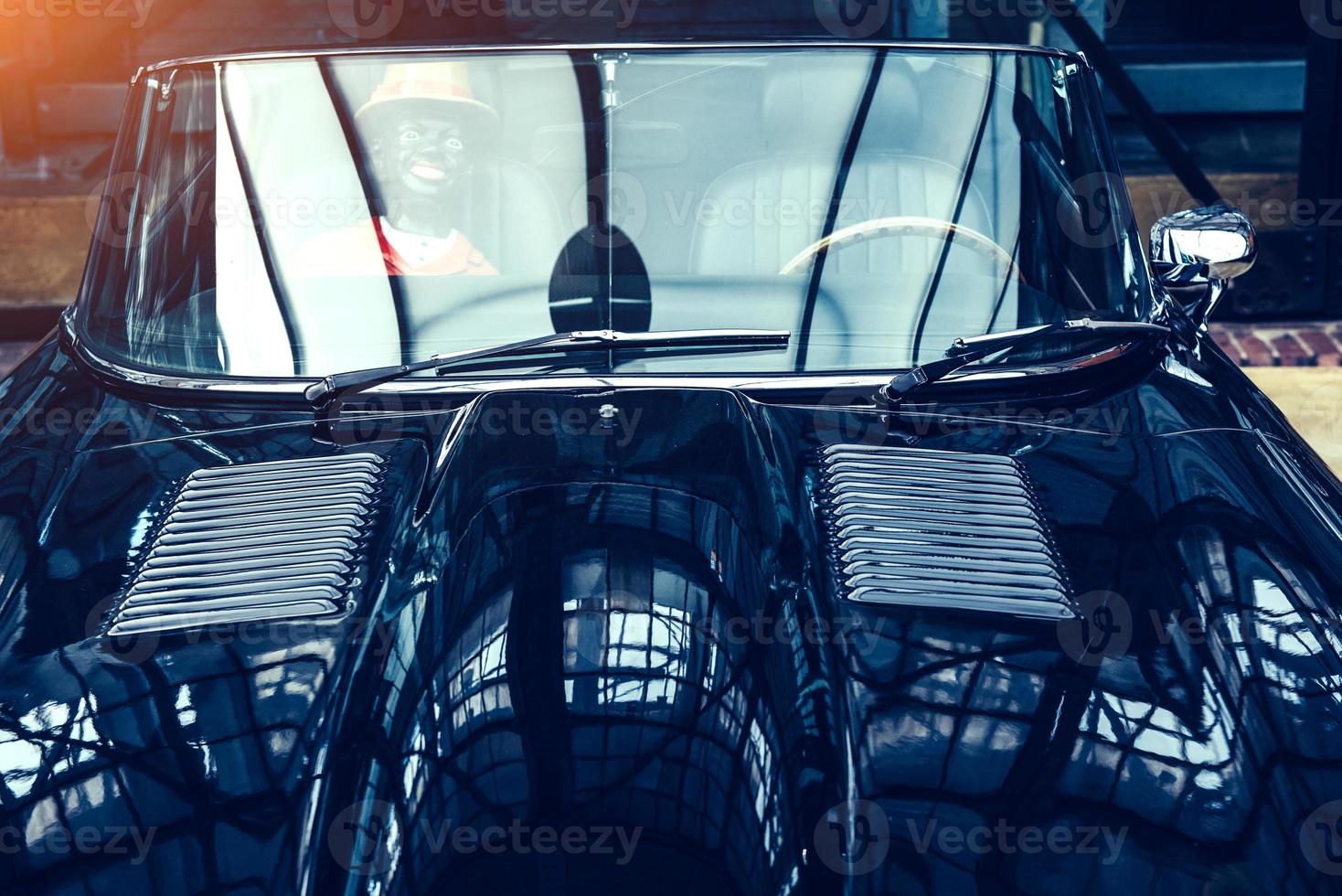 closeup of the headlights and front bumper on vintage automobile photo