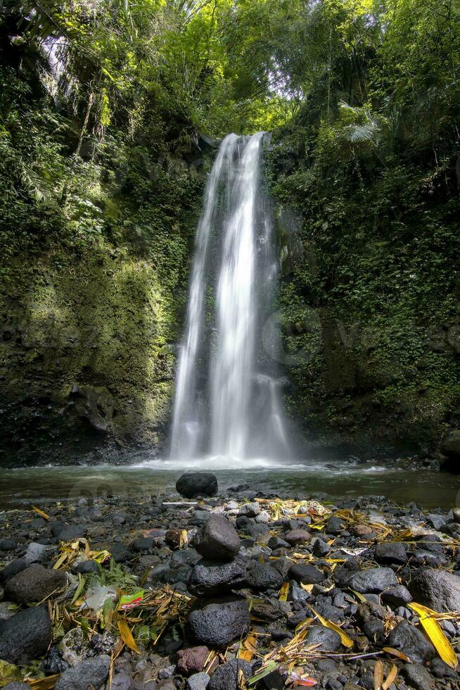 Stunning autumn wallpaper Purbosono hidden waterfall in Wonosobo, Indonesia. photo