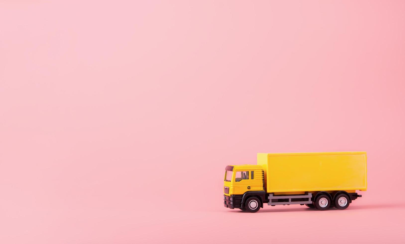 Logistics, and delivery service - Cargo truck and on Pink background. Shopping service on The online web and offers home delivery. with copy space photo
