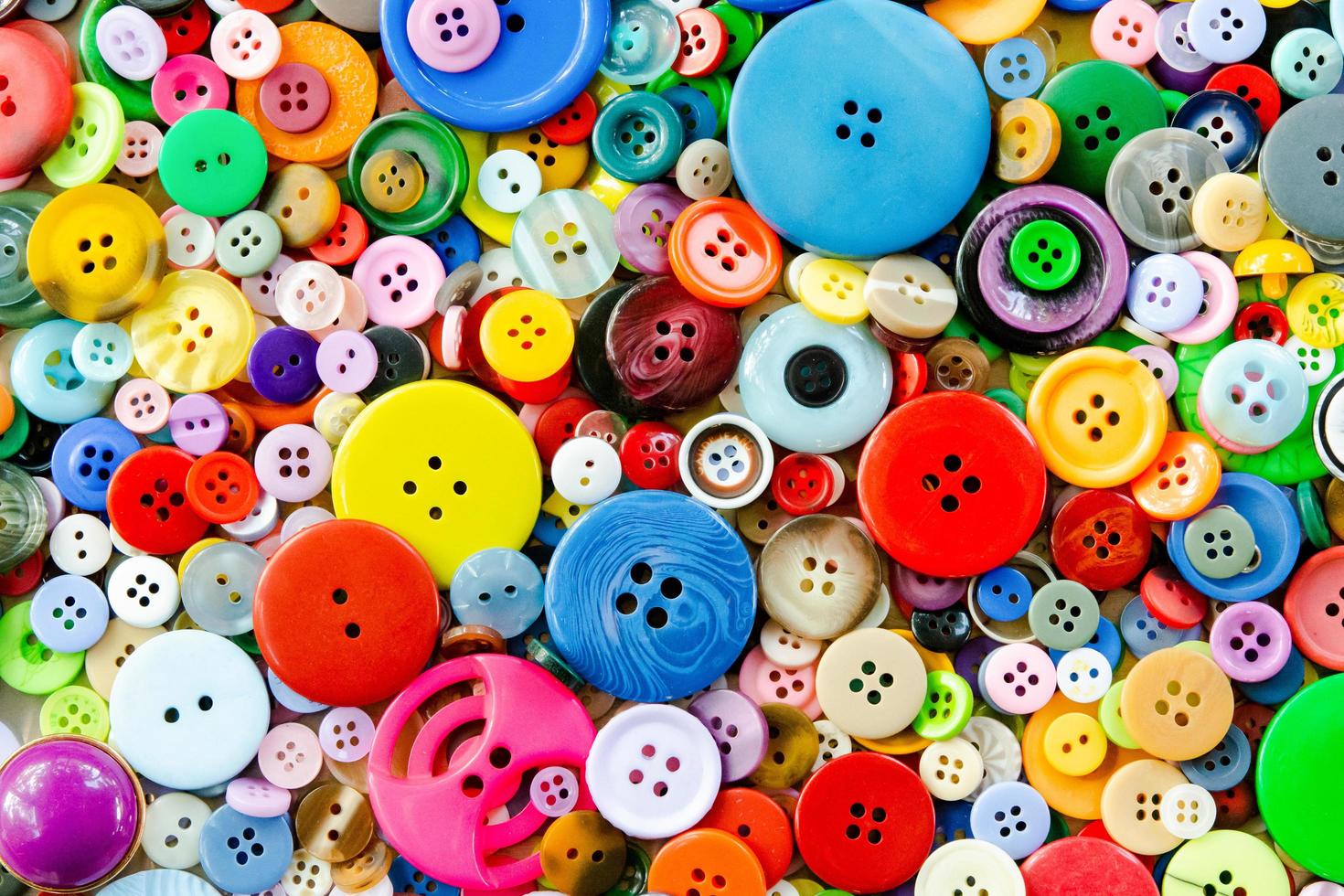 Colorful mixed sewing buttons background. Top view photo