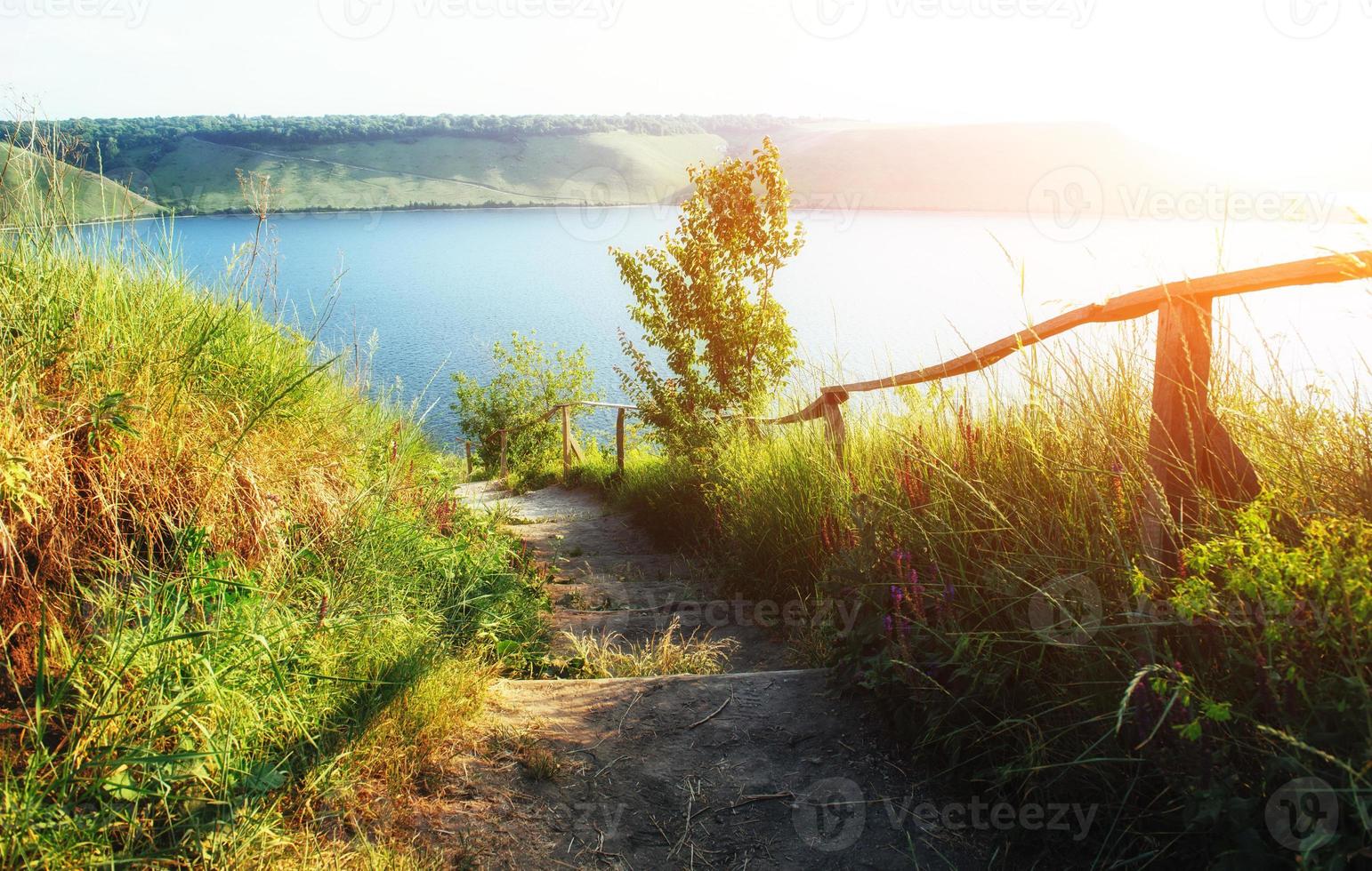 Fantastic views of the trail on the hill leading to the picturesque lake. photo