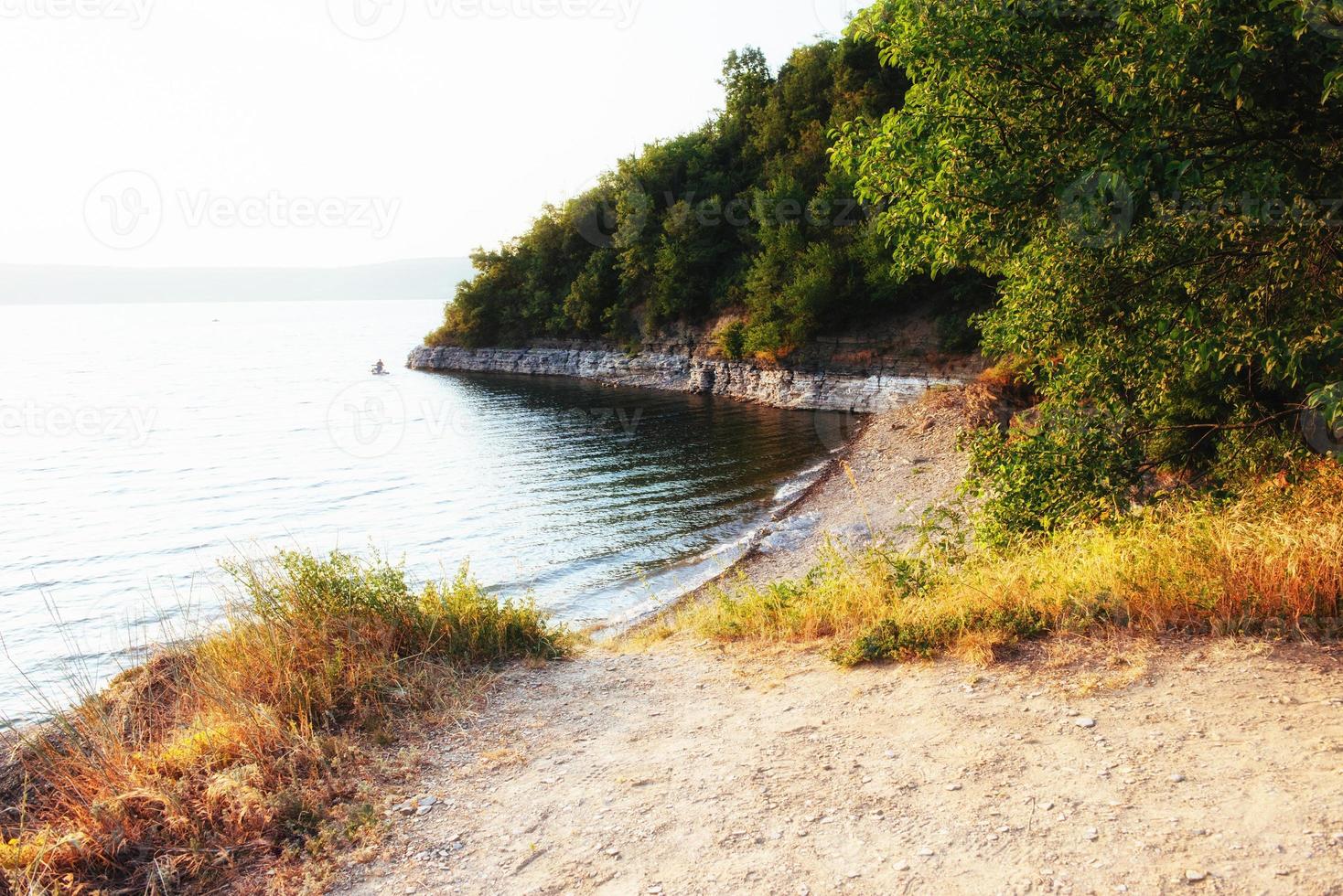 Fantastic views of the trail on the hill leading to the picturesque lake. photo