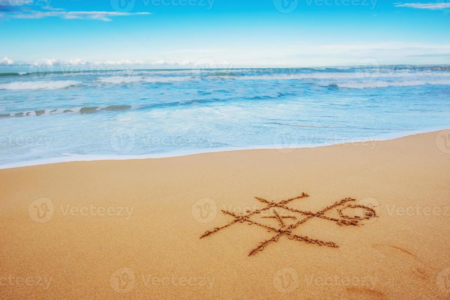 Figures in the sand on the beach photo