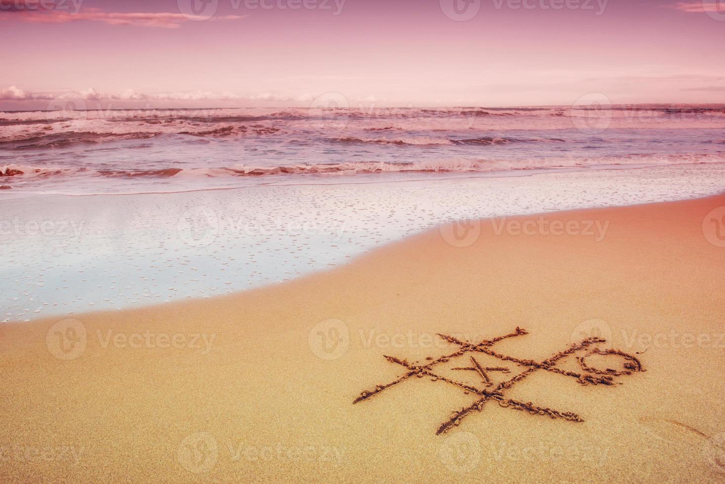 Figures in the sand on the beach photo