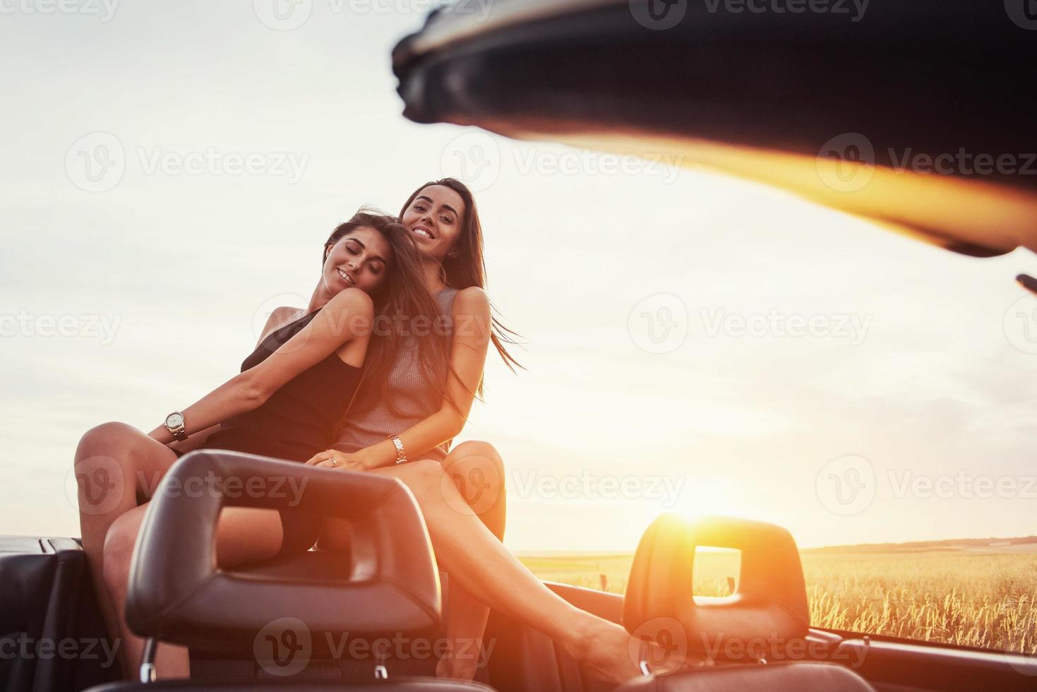 Young two women at a photo shoot. Girls gladly posing
