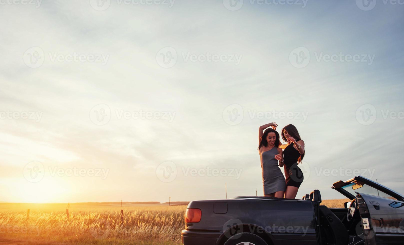 Young two women at a photo shoot. Girls gladly posing