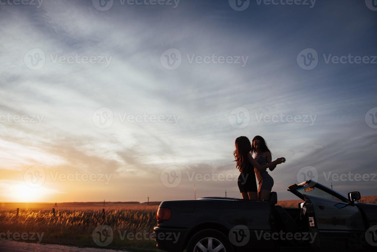 Young two women at a photo shoot. Girls gladly posing