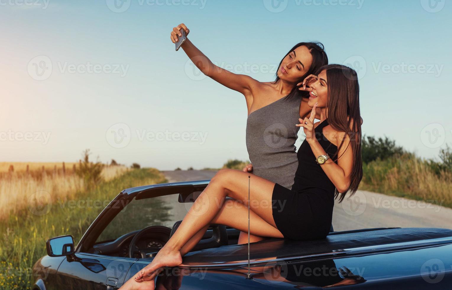 Beautiful two girls are photographed on the road photo