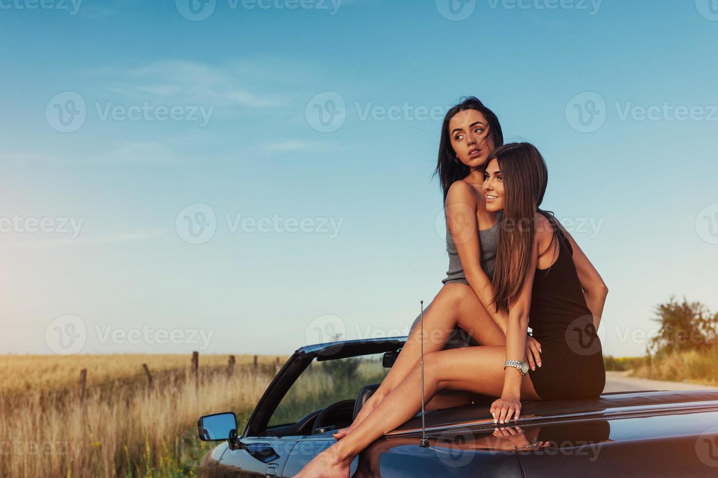 Beautiful two girls are photographed on the road photo