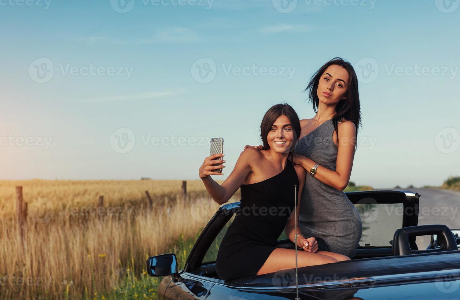 Beautiful two girls are photographed on the road photo