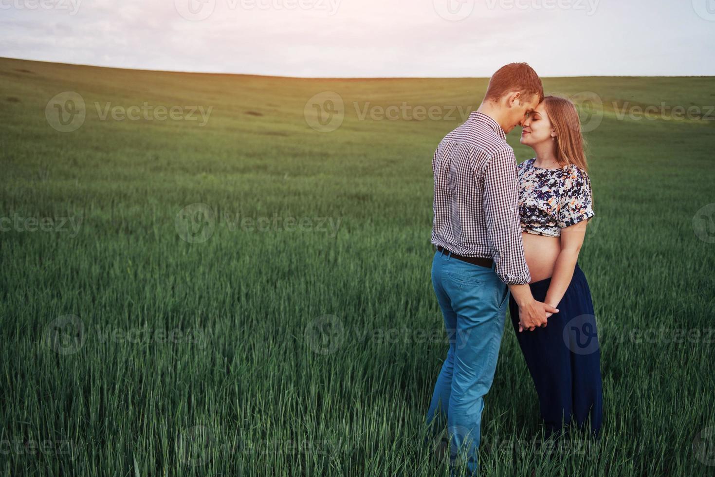 Happy couple awaiting baby. Beautiful and young parents photo