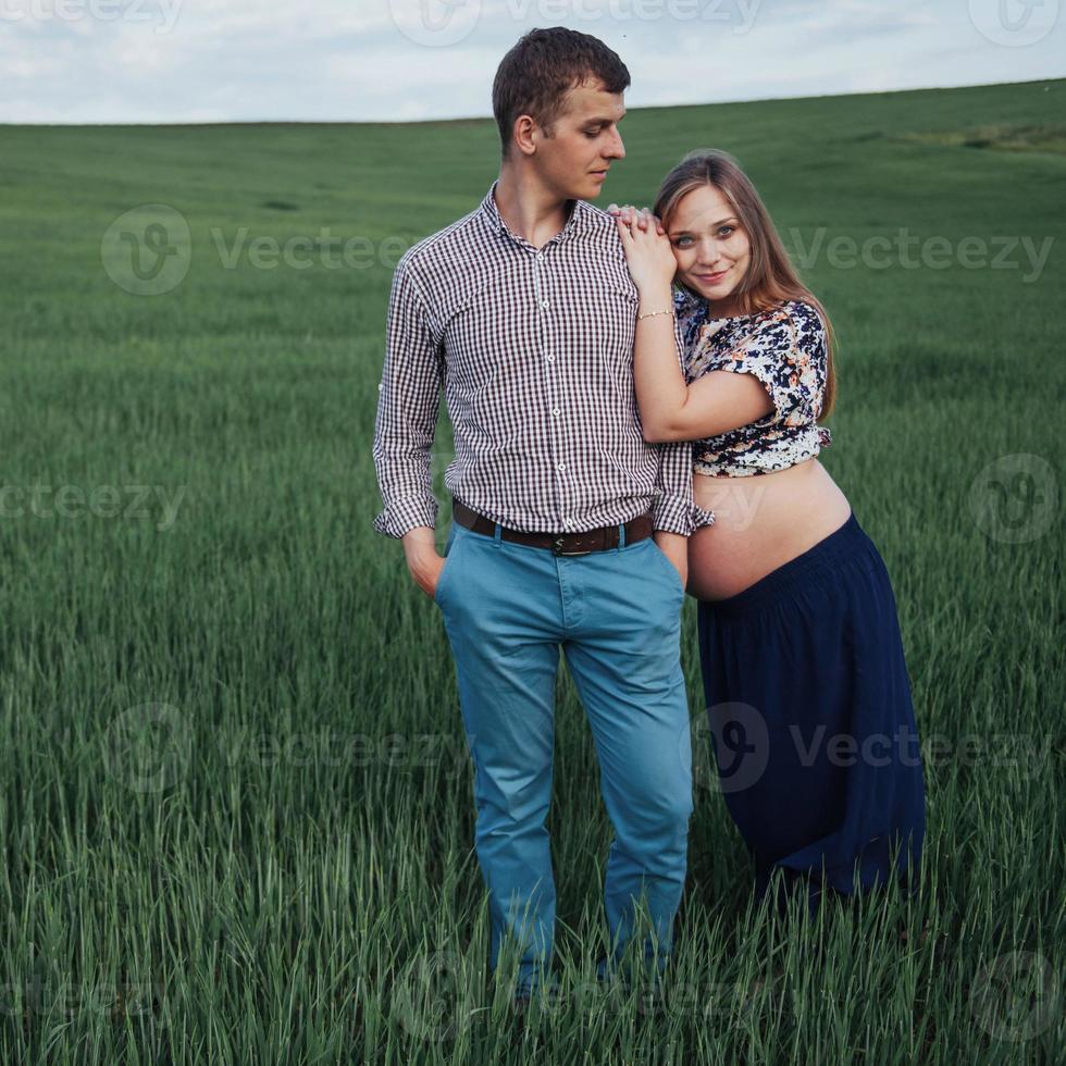 Happy couple awaiting baby. Beautiful and young parents photo