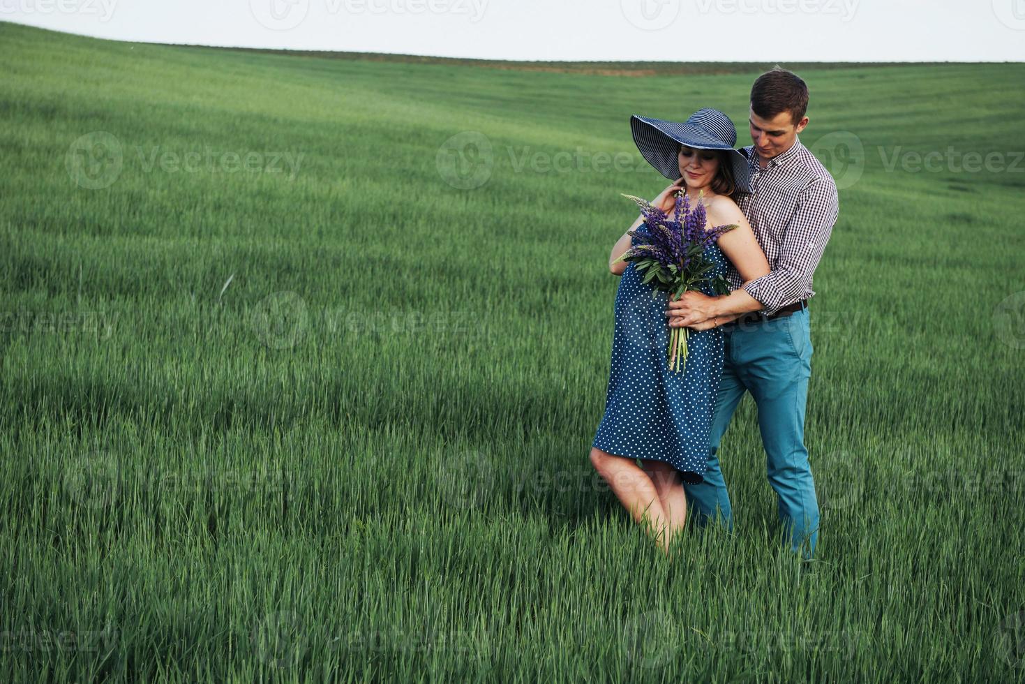 Happy couple awaiting baby. Beautiful and young parents photo