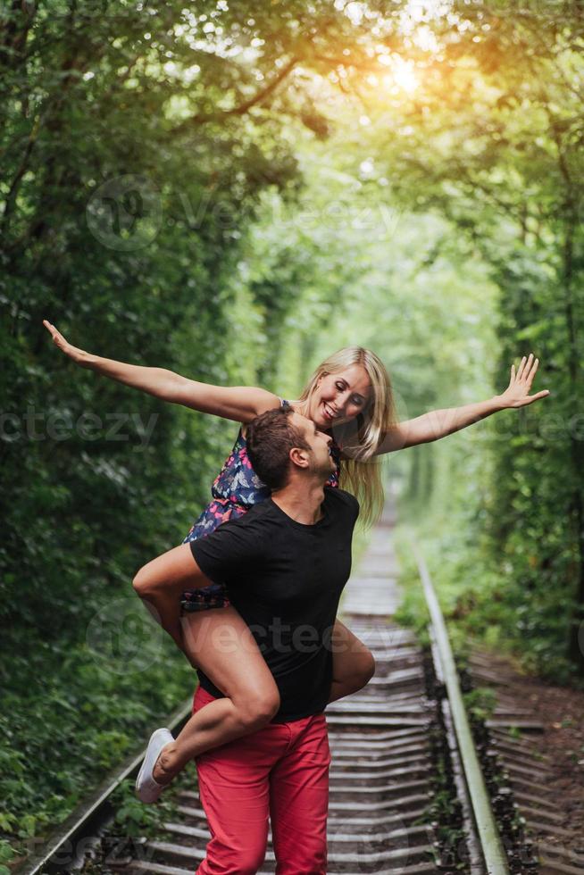 Loving couple in love tunnel iron road photo