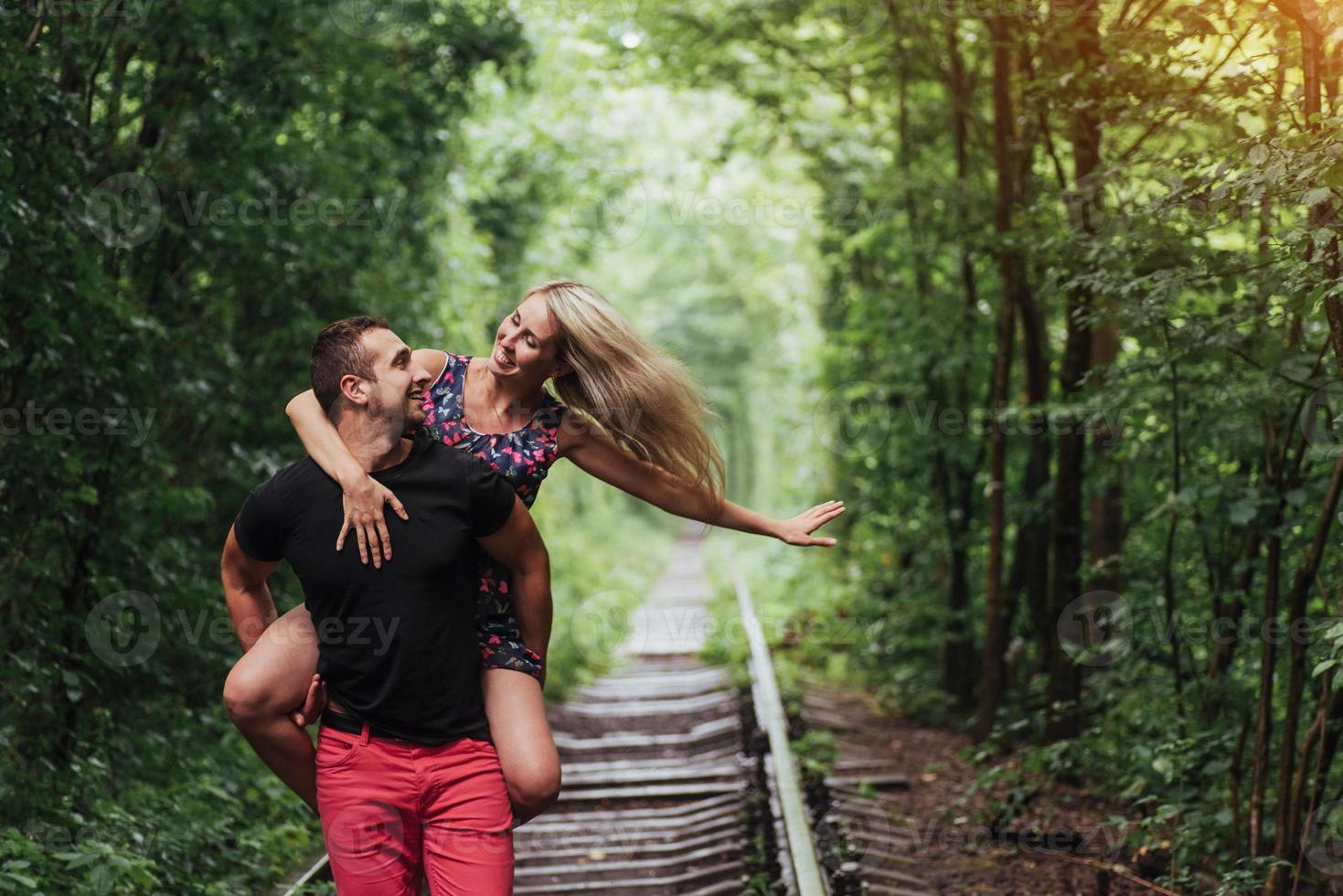 Loving couple in love tunnel iron road photo