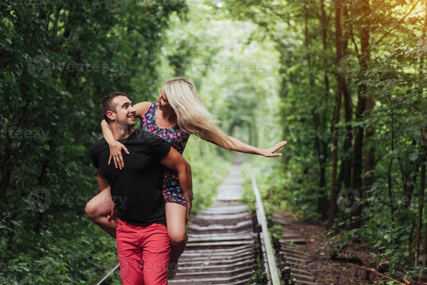 Loving couple in love tunnel iron road photo