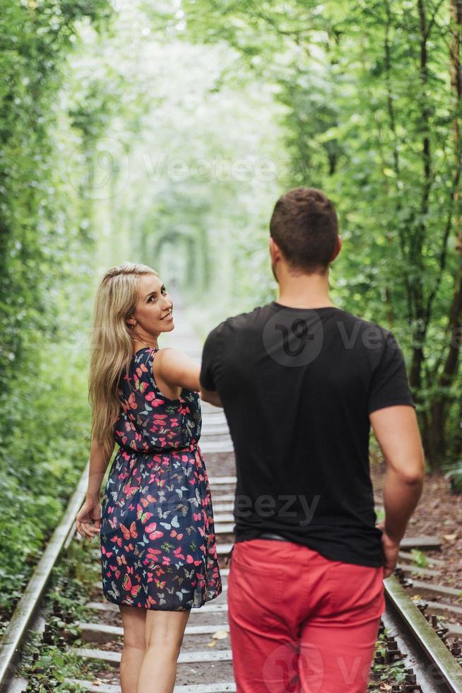 Loving couple in love tunnel iron road photo