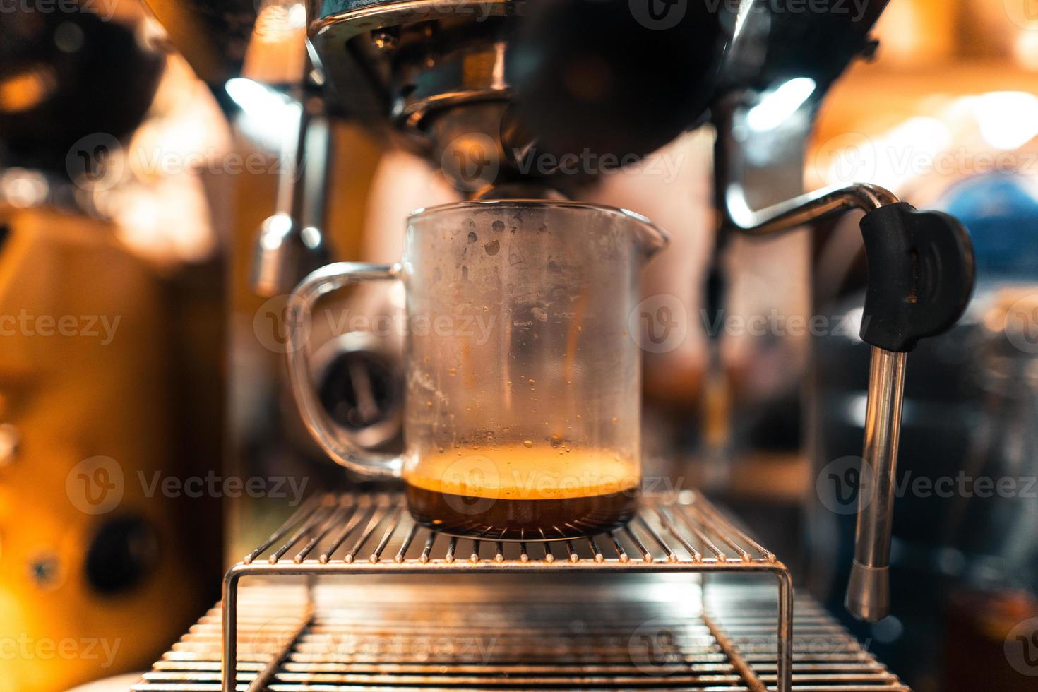Coffee machine and cup of expresso photo