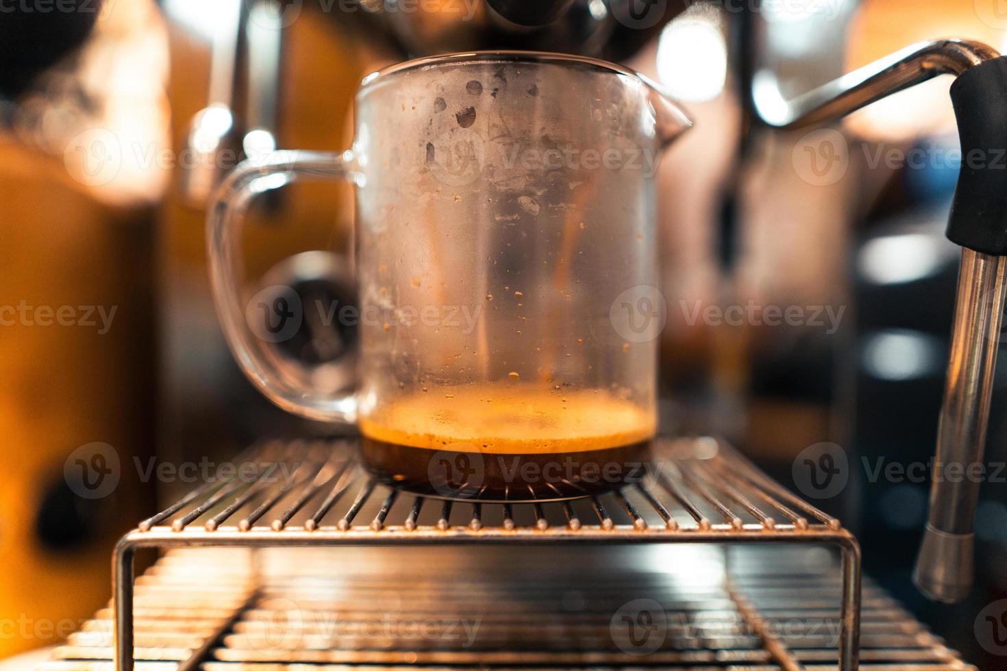 Coffee machine and cup of expresso photo