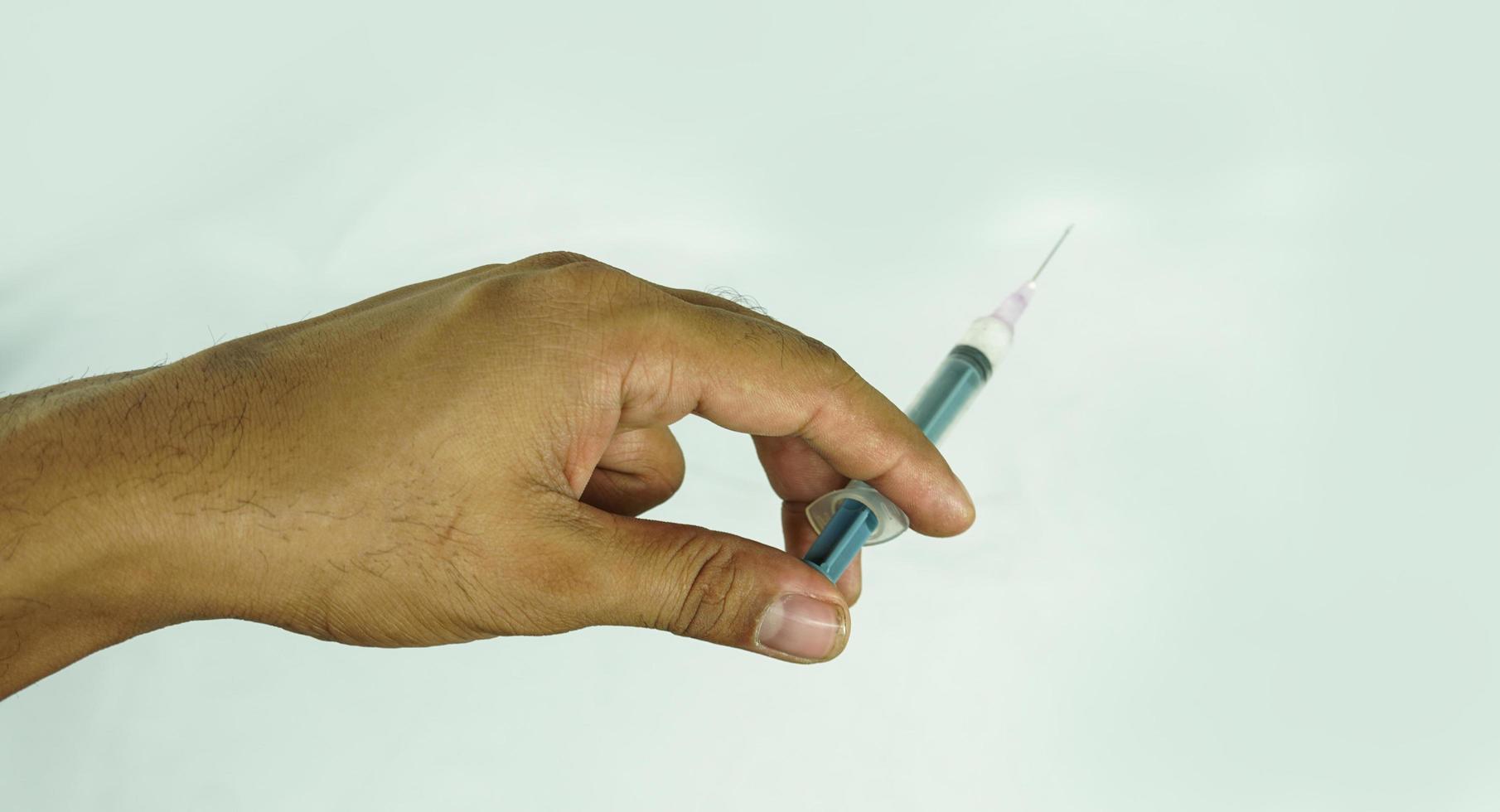 injection in hand on white background photo