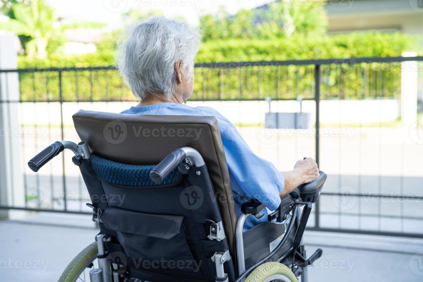 Asian senior or elderly old lady woman patient on electric wheelchair with remote control at nursing hospital ward, healthy strong medical concept photo