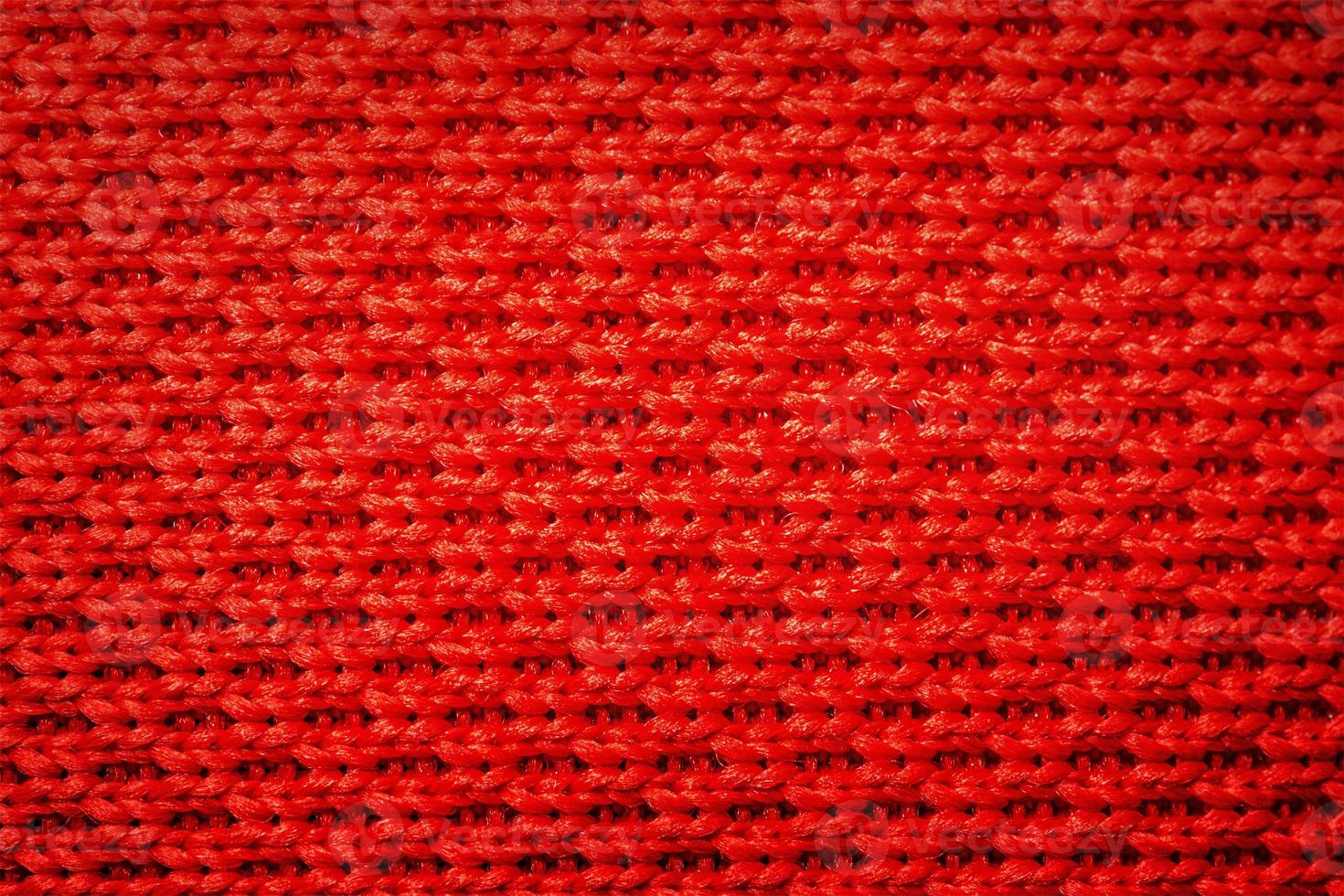 Red knitting fabric weaving as background. Abstract red background. photo
