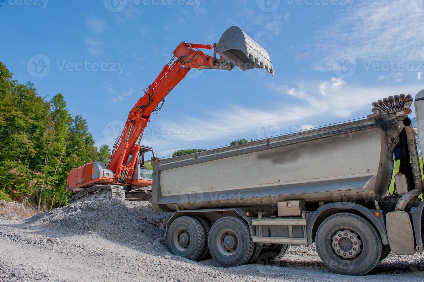 Load of gravel with bulldozer in construction site photo