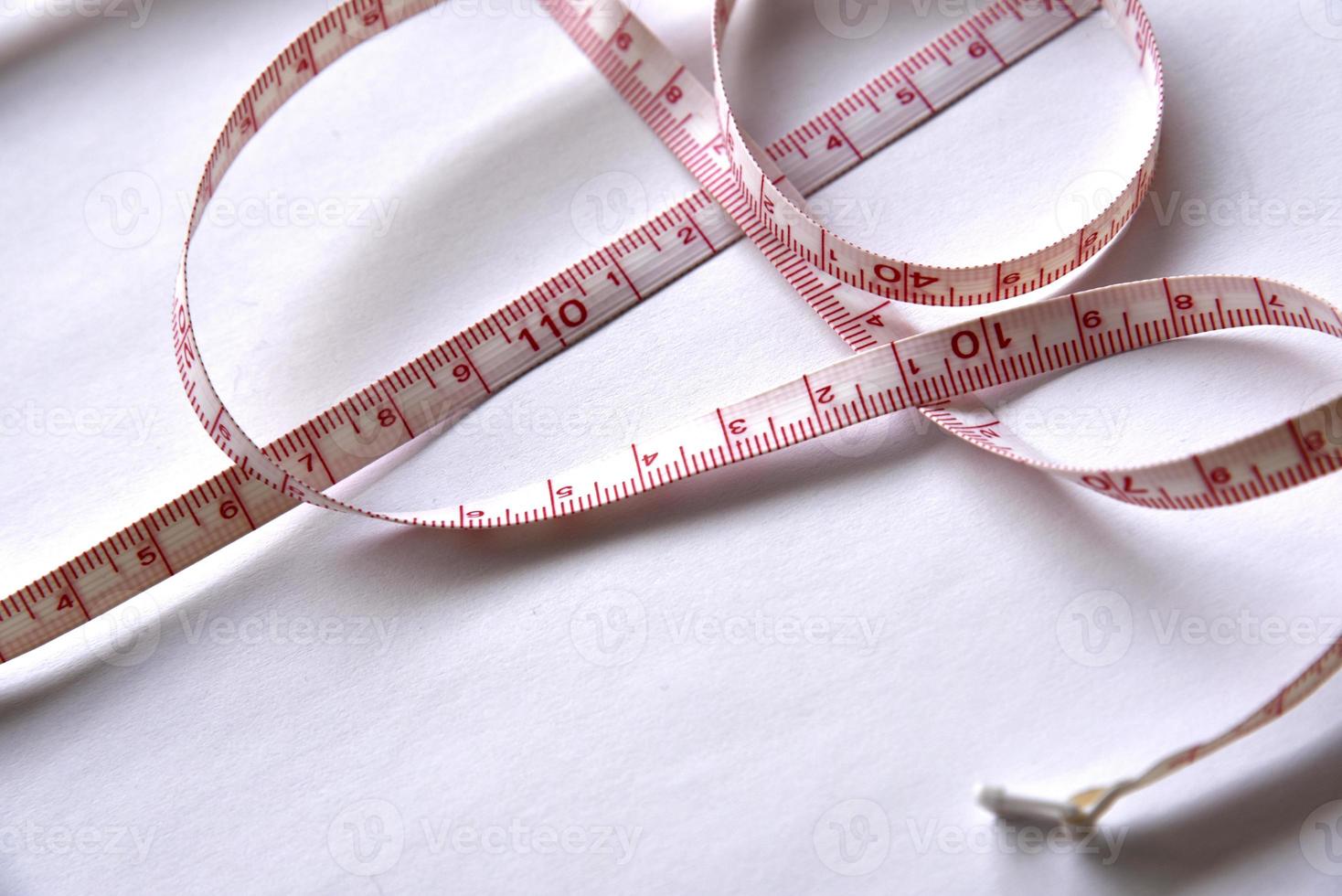 Sewing centimeter centimeter tape tailor's meter measuring tape on a white background photo