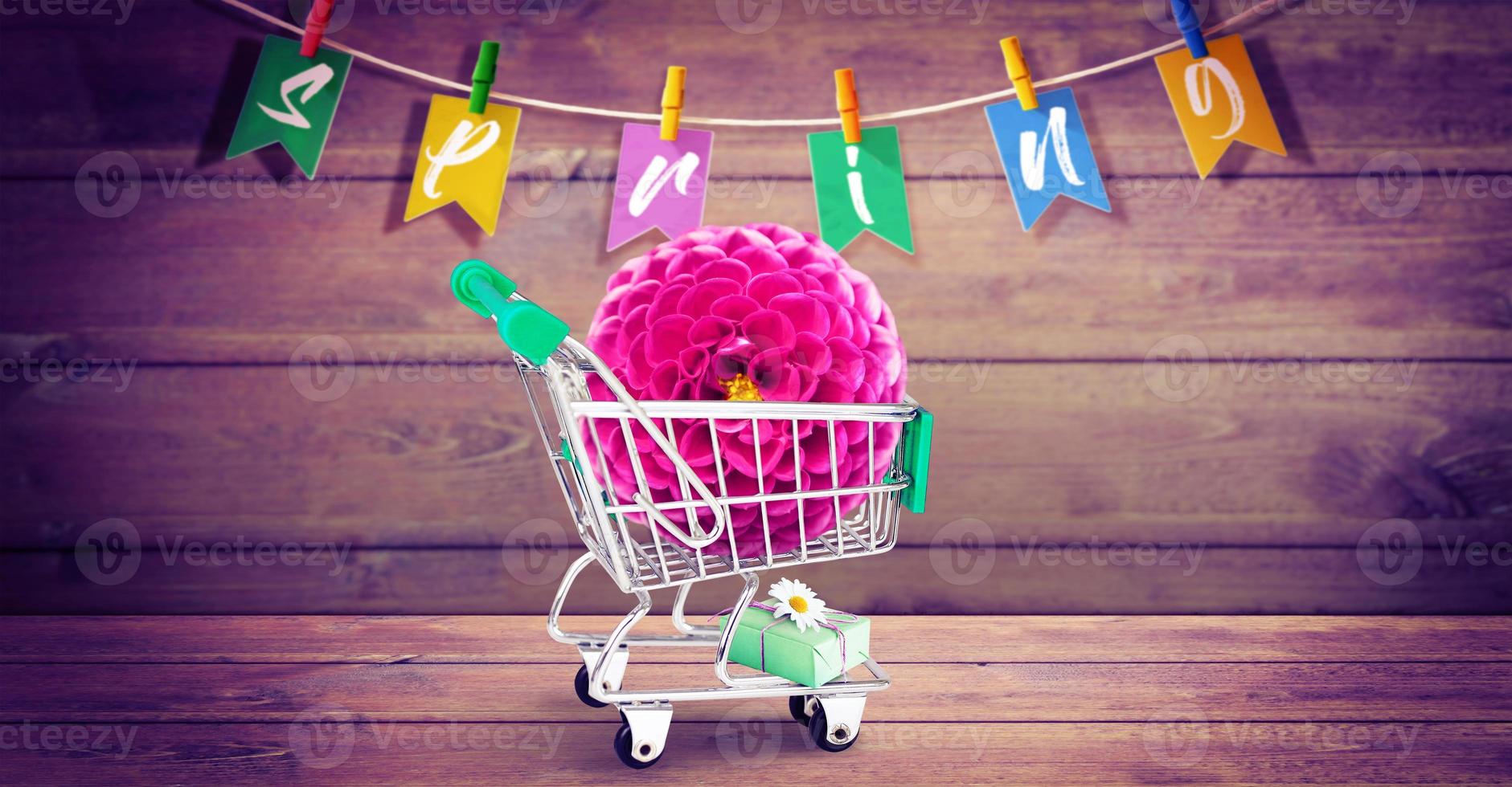 Mini shopping cart with colorful flowers and butterflies. photo