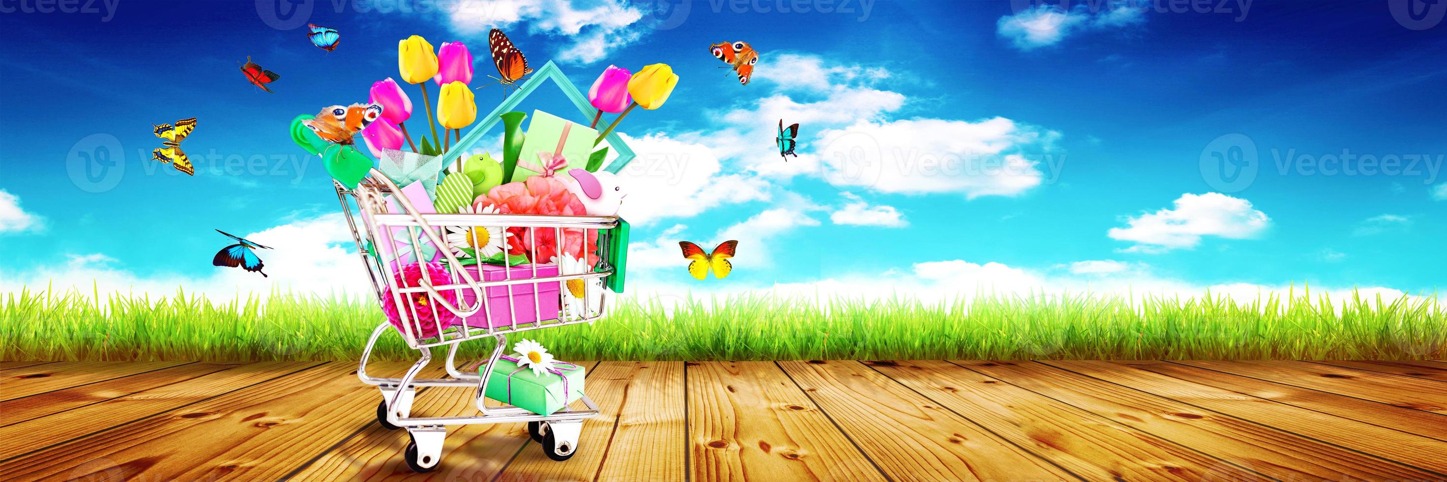 Mini shopping cart with colorful flowers and butterflies. photo