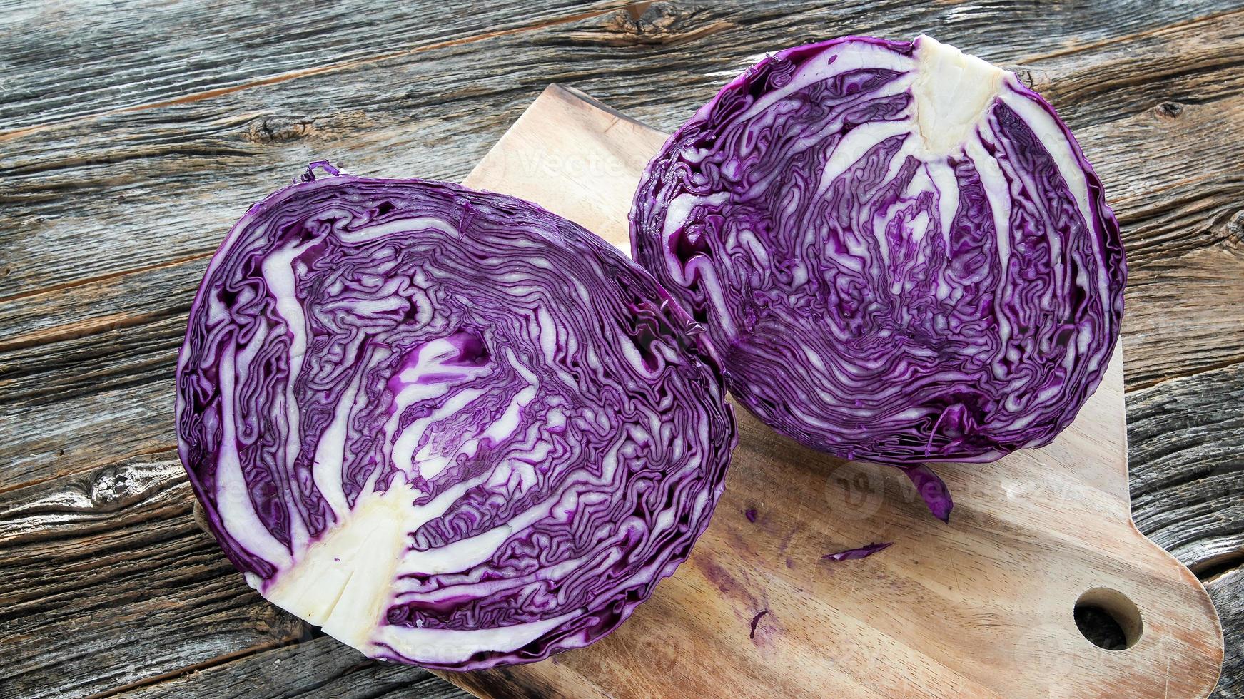 Red cabbage  cut on half on cutting board photo