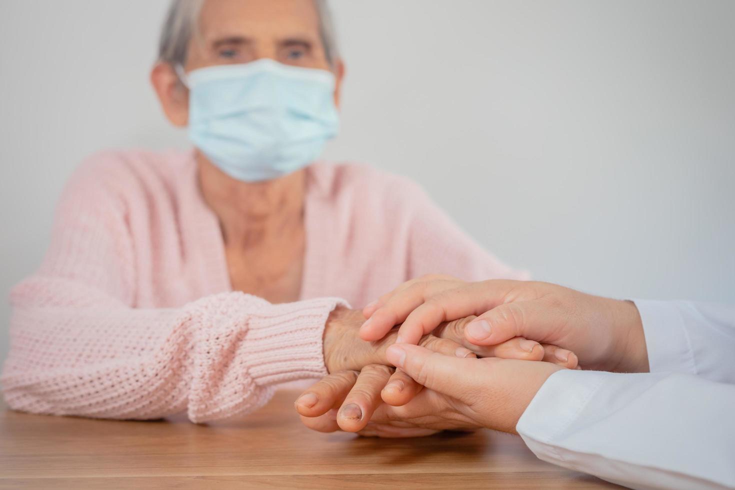 The doctor shook the patient's hand as a sign of encouragement. photo