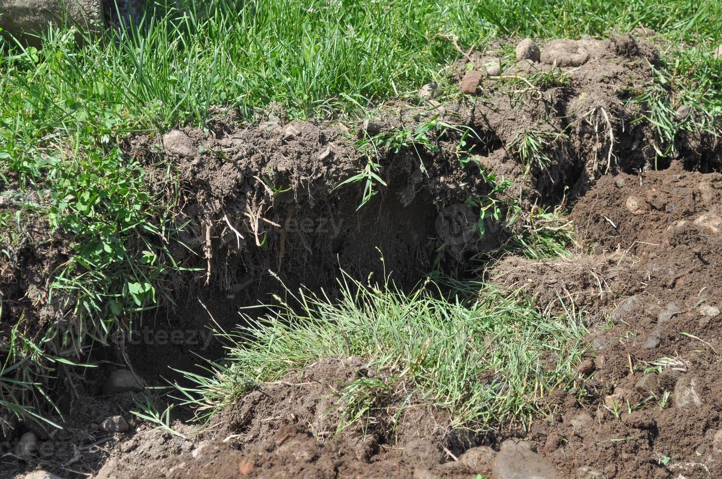 Excavator digging a hole photo