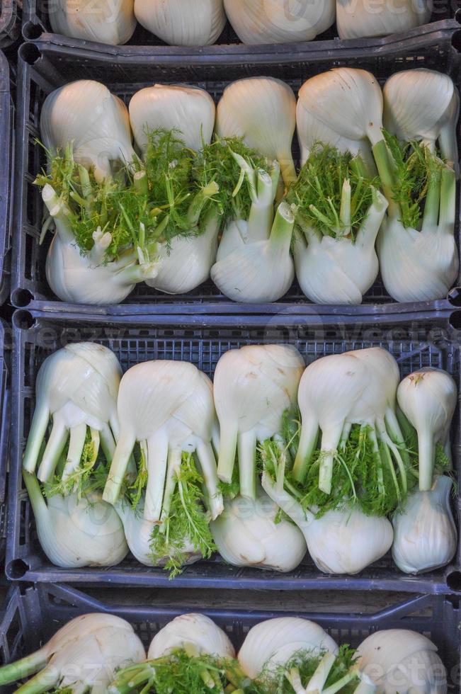 Fennels vegetables in crate on a market shelf photo