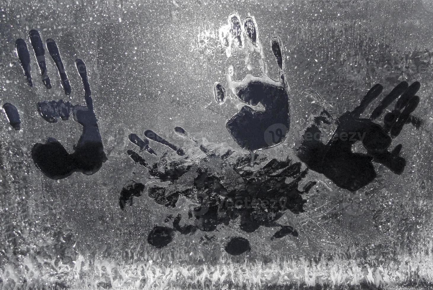 Handprints on frozen car window in Norway. photo