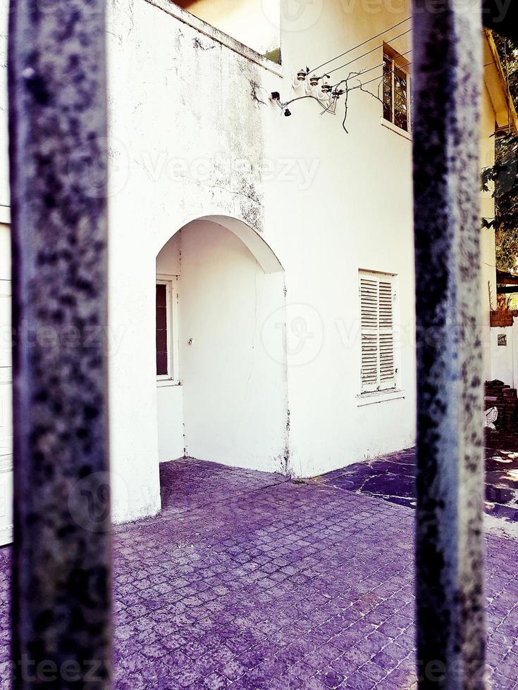 Nostalgic old purple white building behind a fence, Cape Town. photo