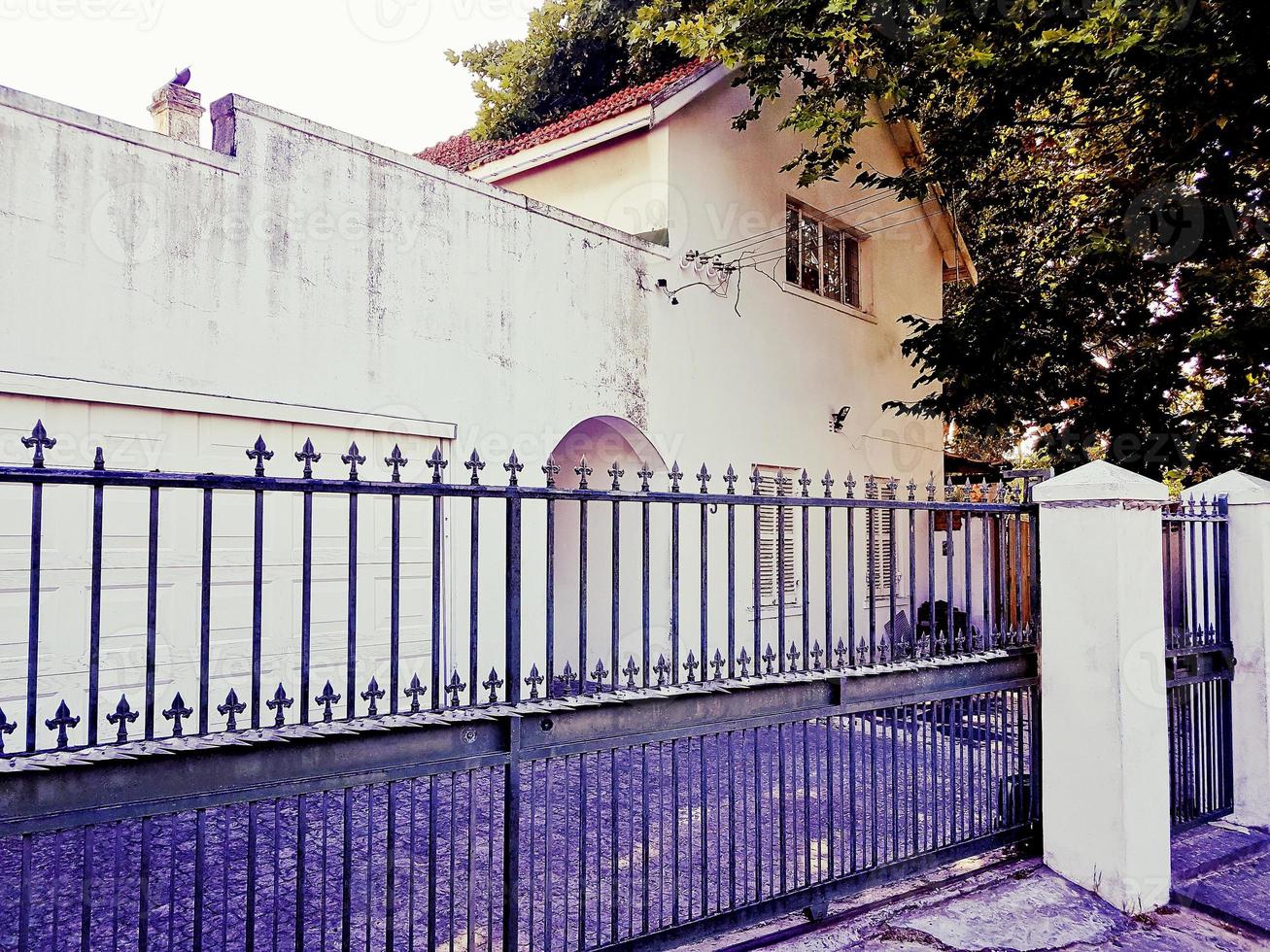 Nostalgic old purple white building behind a fence, Cape Town. photo