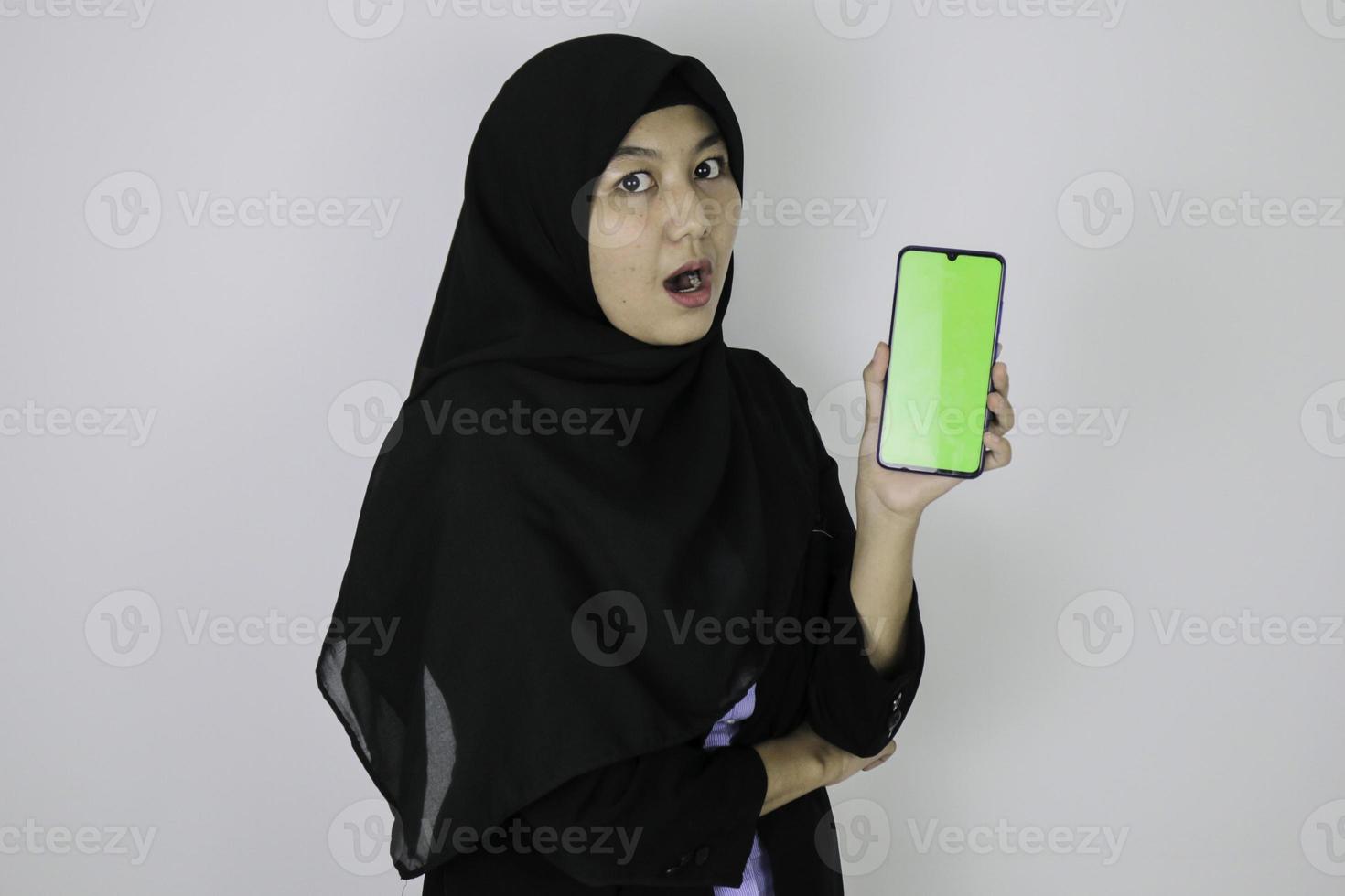 Shock government worker women showing blank screen on smartphone. PNS wearing khaki uniform. photo