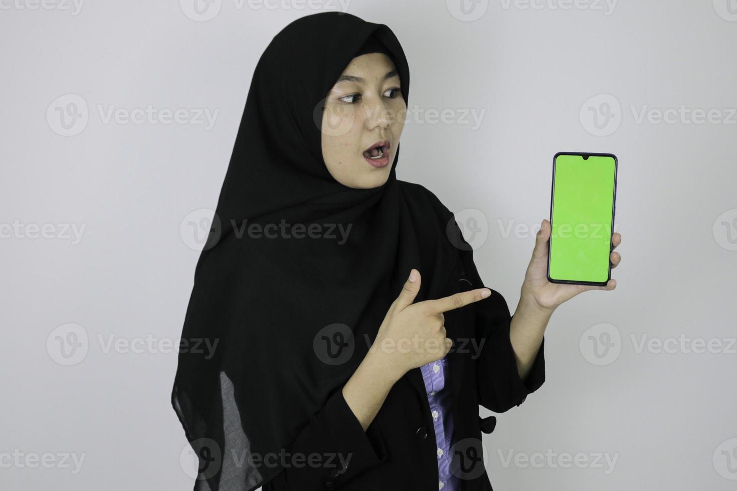 Shock government worker women showing blank screen on smartphone. PNS wearing khaki uniform. photo