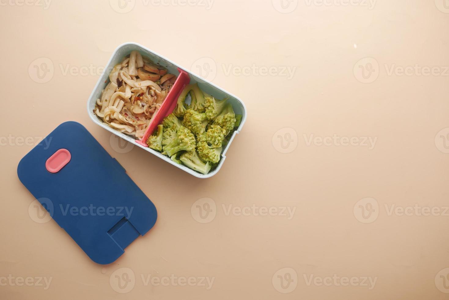 top view of a lunch box on color background photo