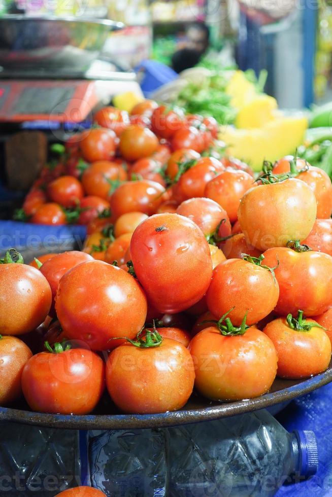 fresh tomato with water drop display for sale at local store photo